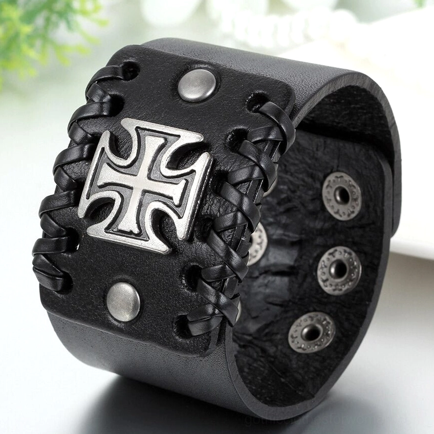Black leather cuff bracelet front close-up - detailed view of Celtic cross decoration and woven leather edges