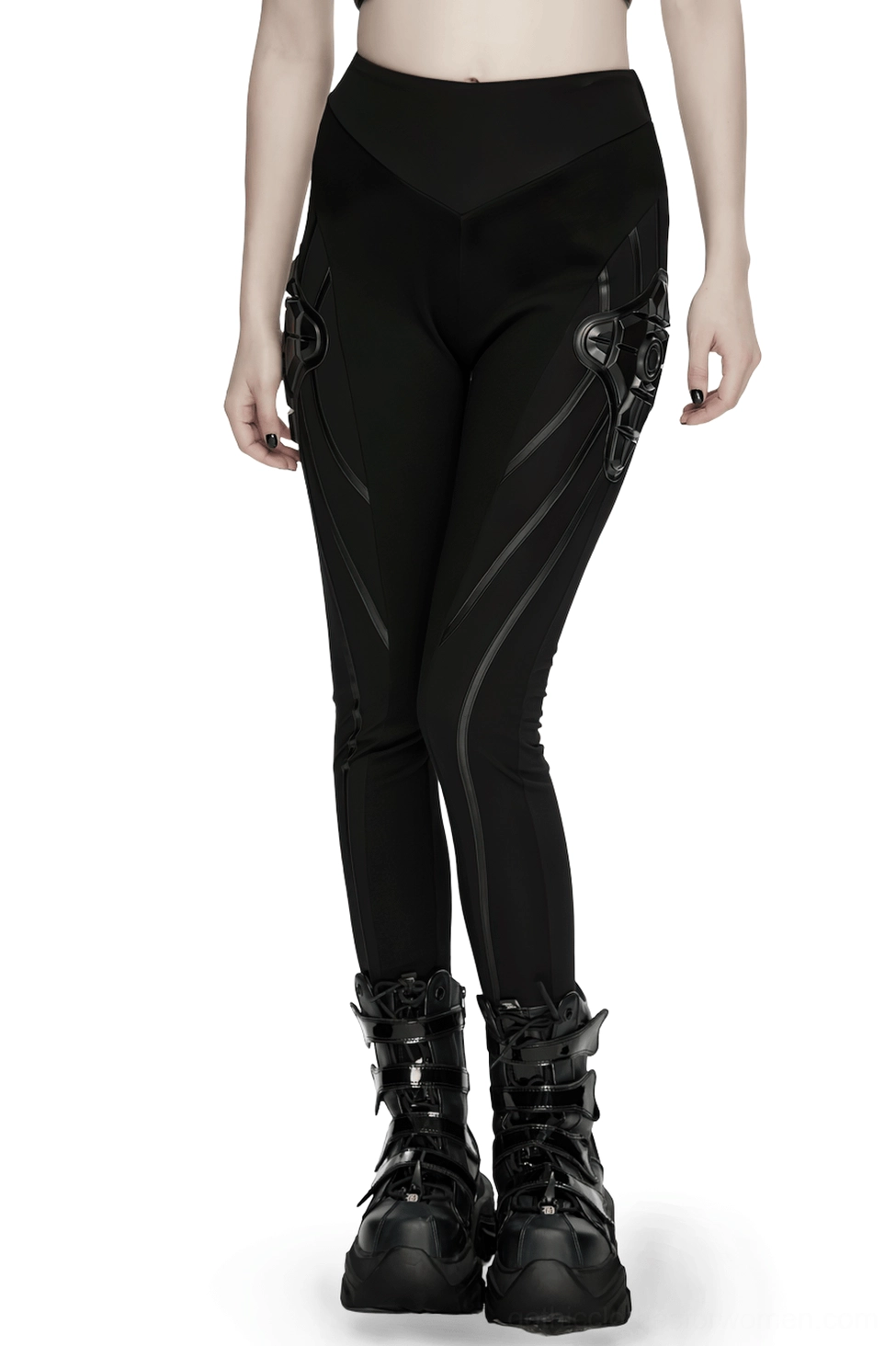 Black cyberpunk armor leggings with 3D side panels worn on female model, front three-quarter view showing segmented seaming and sculptural hip armor elements
