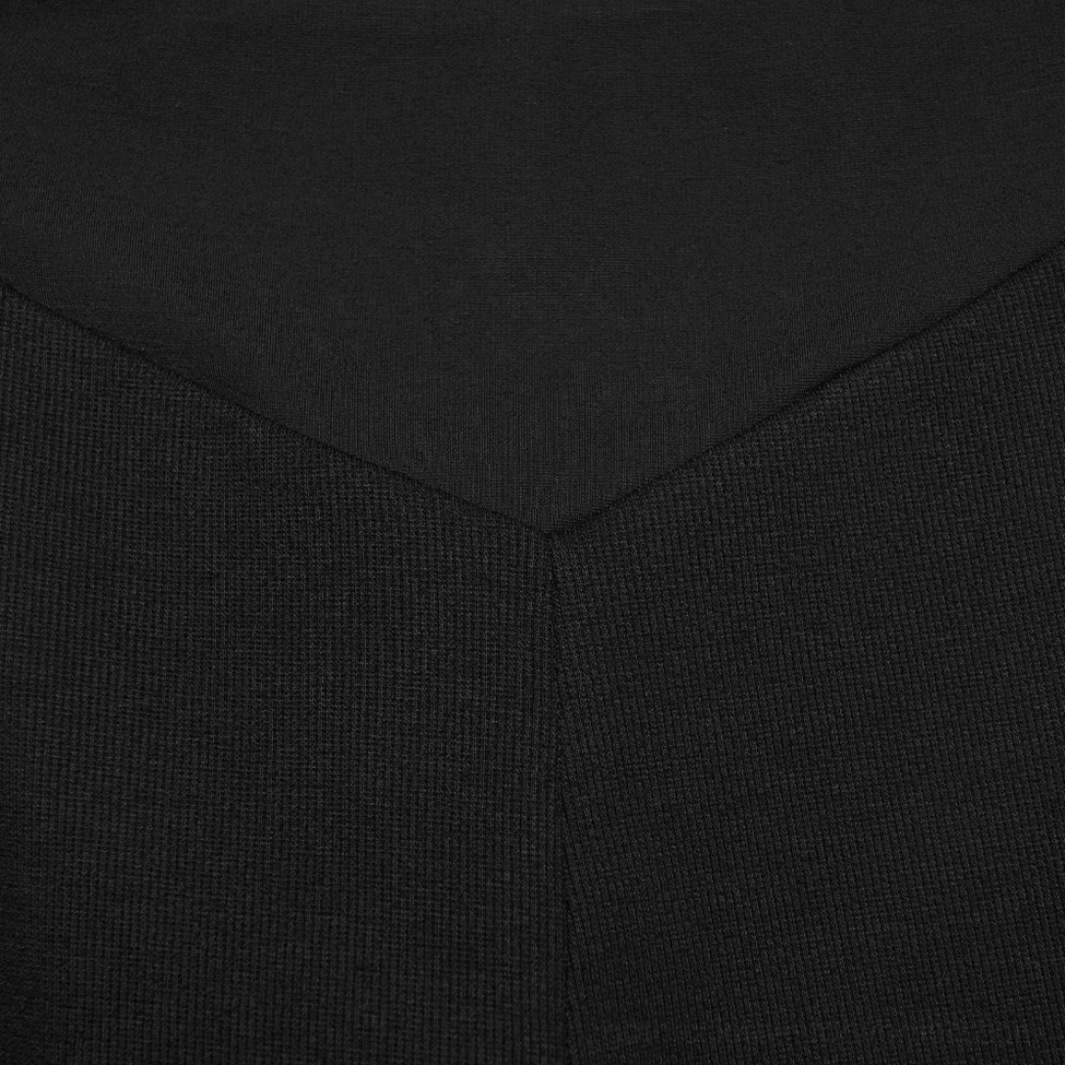 Black cyberpunk armor leggings architectural design detail showing precision-engineered segmented seaming and structural panel construction