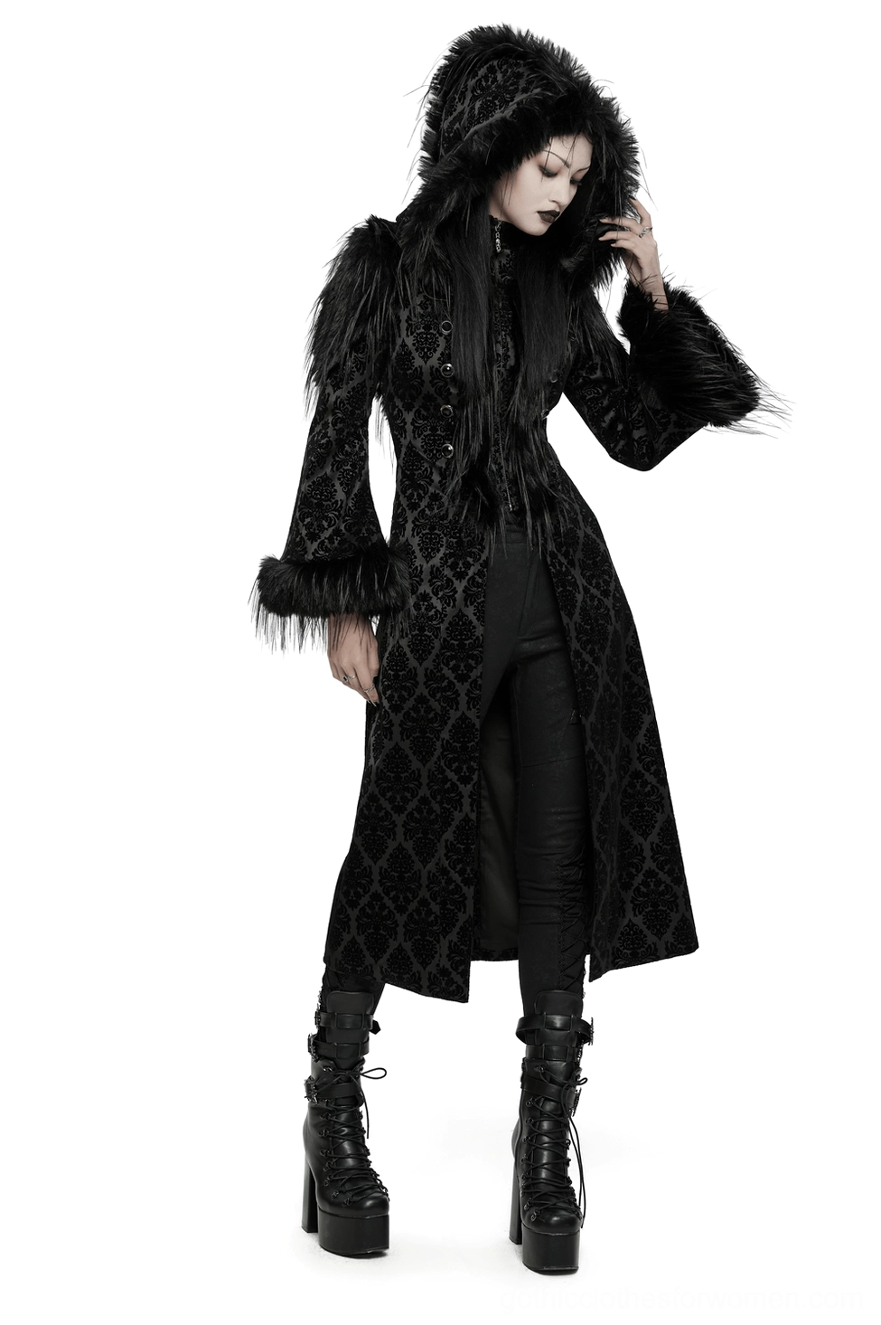 Black damask jacquard hooded gothic coat with faux fur trim and gemstone buttons, front three-quarter view on model