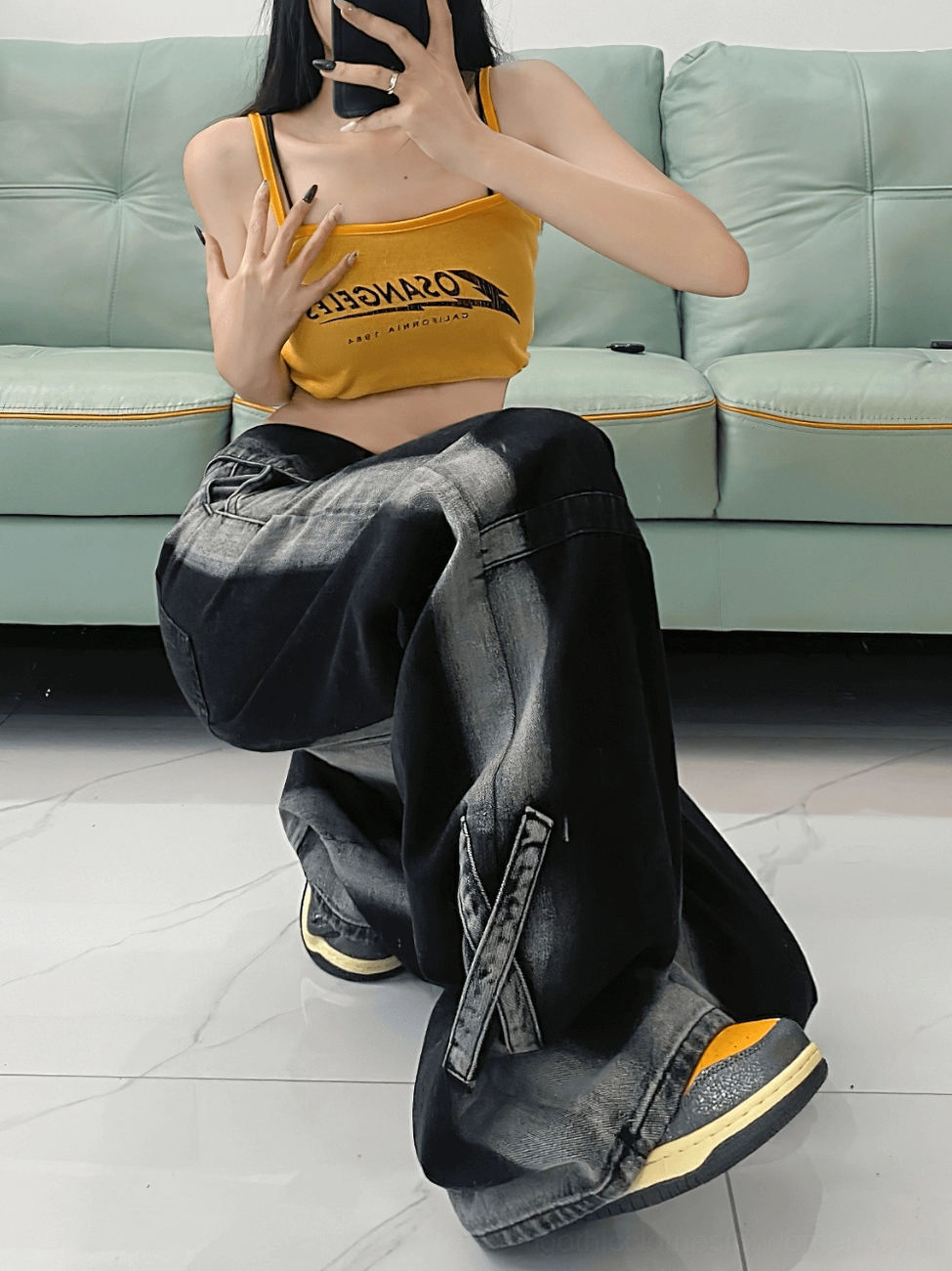 Black high-waist straight denim jeans styled with casual sneakers, showcasing dark blue faded wash and versatile fit
