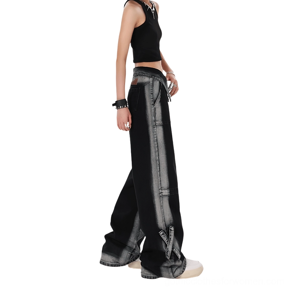 Side view of women's black faded denim pants with folded waistband and hem strap details