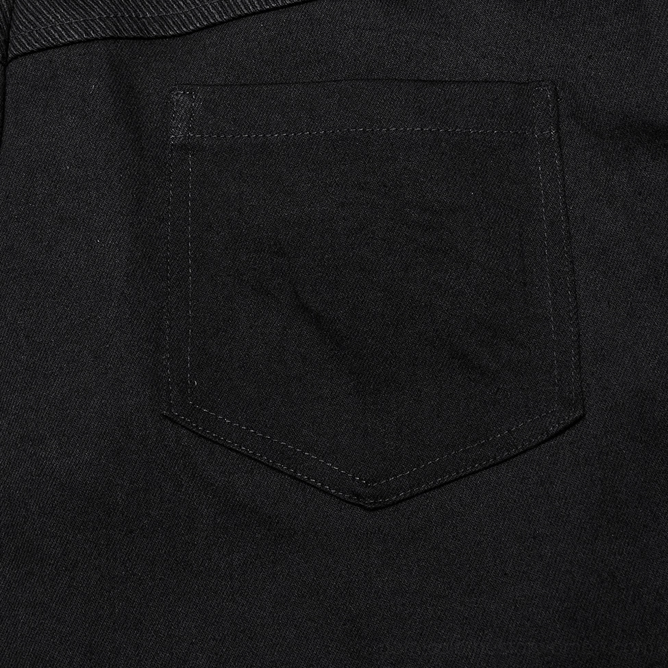 Back pocket stitching detail, solid black denim construction, alternative skirt craftsmanship close-up