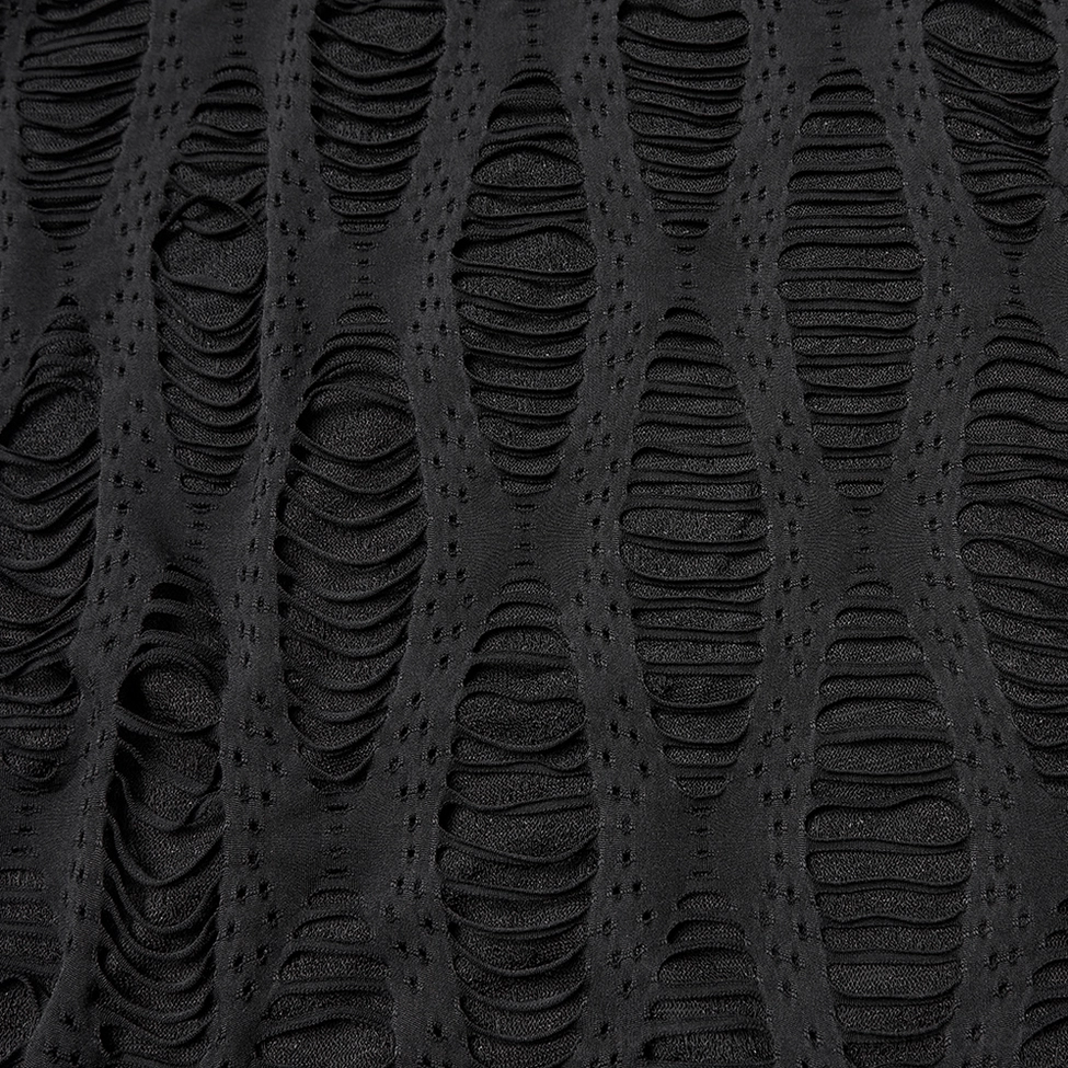 Black destroyed knit cardigan texture close-up - neat vertical ripped hollow pattern on matte fabric