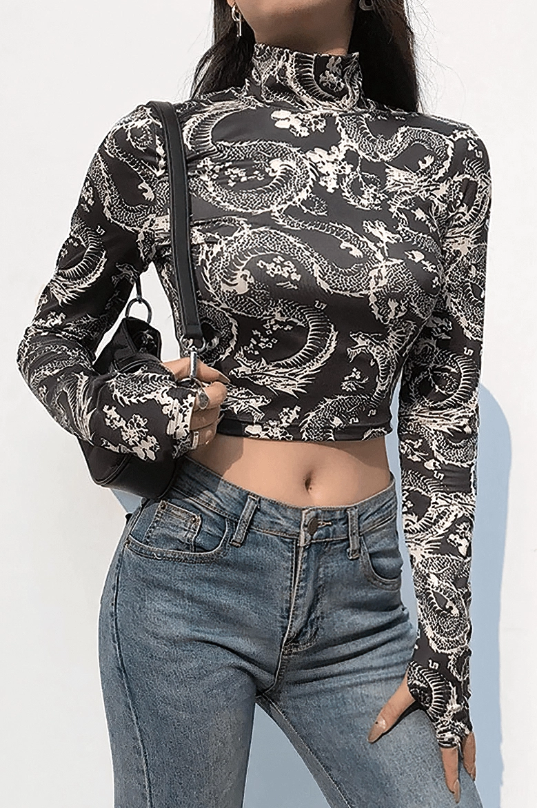 Black dragon gothic crop top styled with blue jeans and thumb hole cuffs on female model
