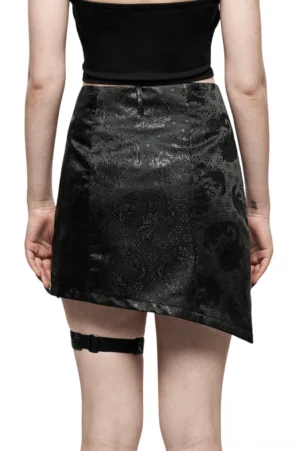 Rear view of black dragon jacquard asymmetrical gothic skirt on model, displaying high waist, tonal dragon pattern, and asymmetrical hemline