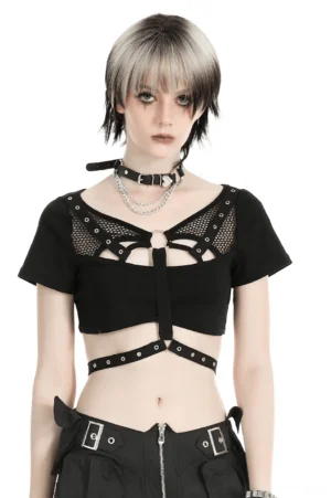 Black fishnet gothic crop top with metal O-ring harness worn by model, front view