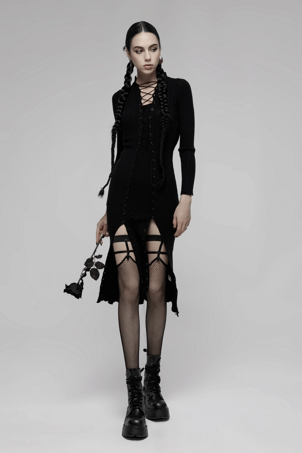Black fishnet knee-high socks with skull rivet details, product styling showcase