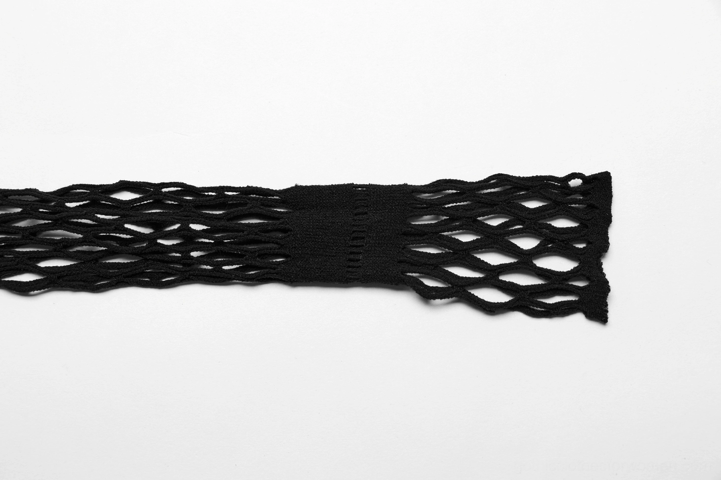 Black fishnet fabric texture close-up - diamond mesh weave detail