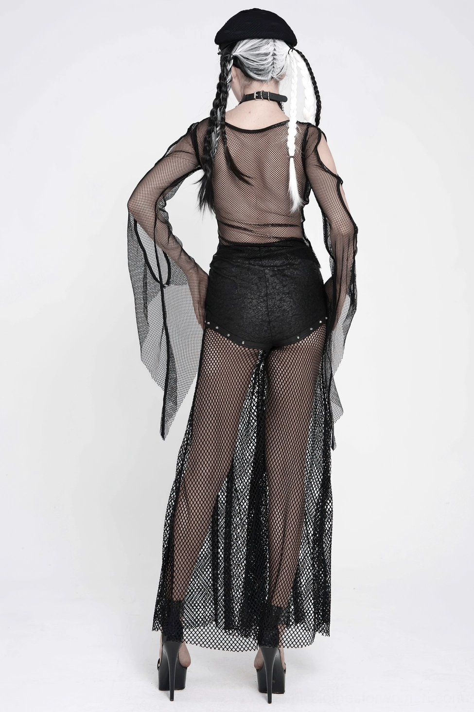 Club and festival wear styling of black fishnet chain lace-up flare pants with crop top