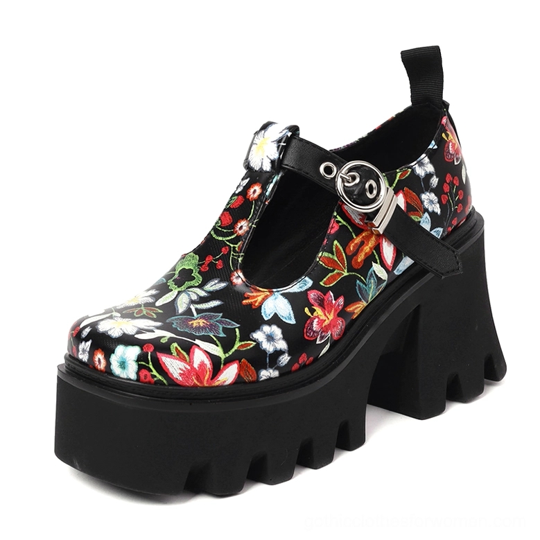 Black floral gothic platform Mary Jane pump with lug sole, round toe and T-strap buckle detail, front three-quarter angle