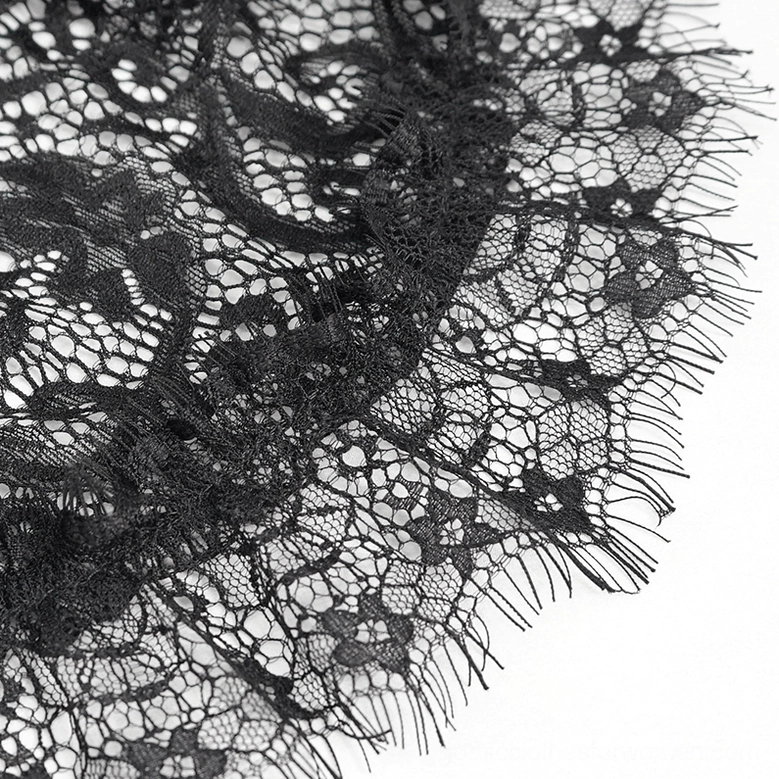Black floral lace pattern close-up showing eyelash frill trim and gothic textile detail