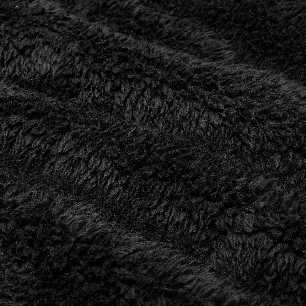 Close-up texture detail of thick fuzzy black fleece fabric on gothic hooded jacket