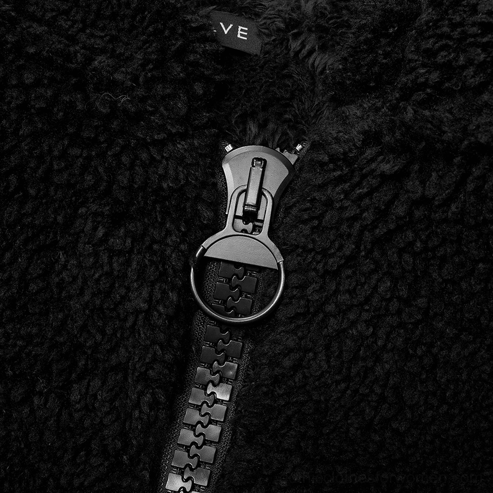 Close-up detail of metal circular zipper pull tab on black fox ear gothic hooded fleece jacket
