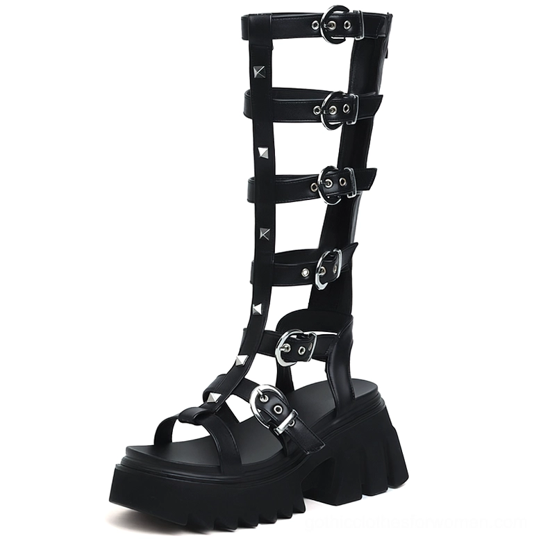 Black patent leather gladiator sandals featuring peep toe design, chunky lug platform sole, and silver D-ring hardware, front right view