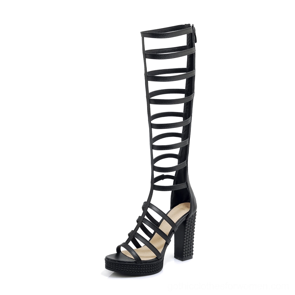Black knee-high gladiator heel sandal inner side view displaying textured block heel and open toe design