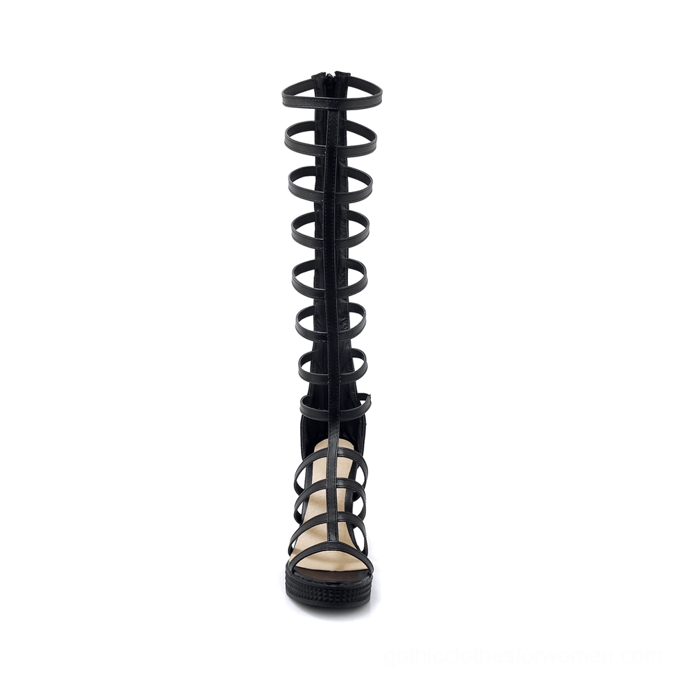 Black knee-high gladiator heel sandal rear back view displaying textured block heel and functional back zipper