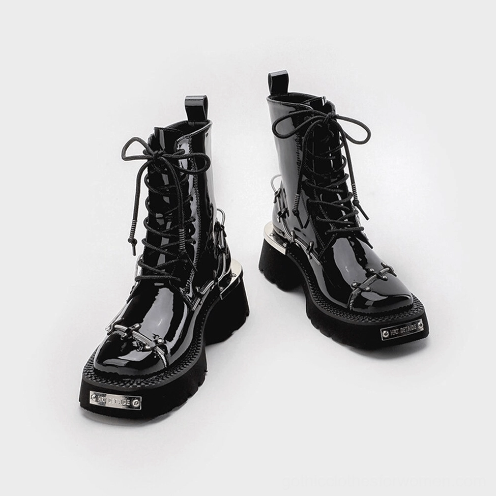 Front-facing view of black patent leather gothic ankle boots with square toe and metal chain accents, platform heel