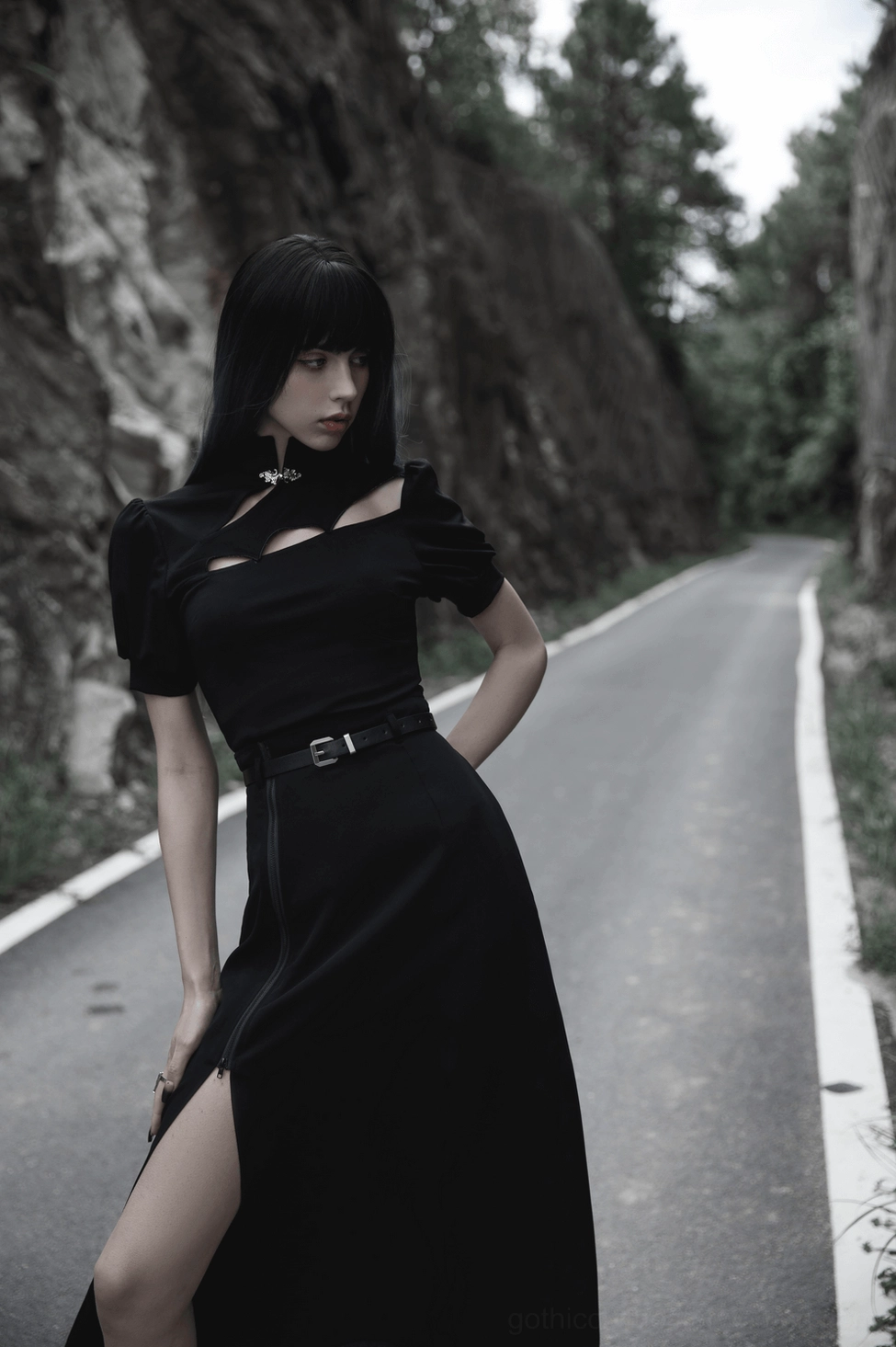 Black gothic A-line midi skirt with side zipper and adjustable slit worn by alternative fashion model in studio product photography