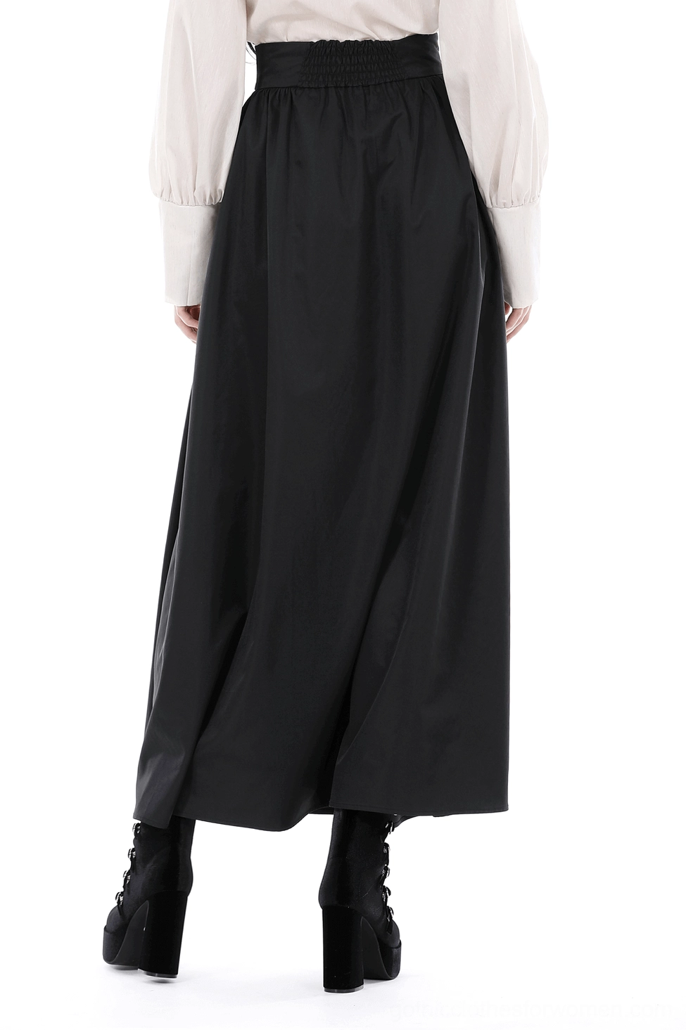 Black gothic skirt back view showing smocked waist design and full floor-length flowing hem on model