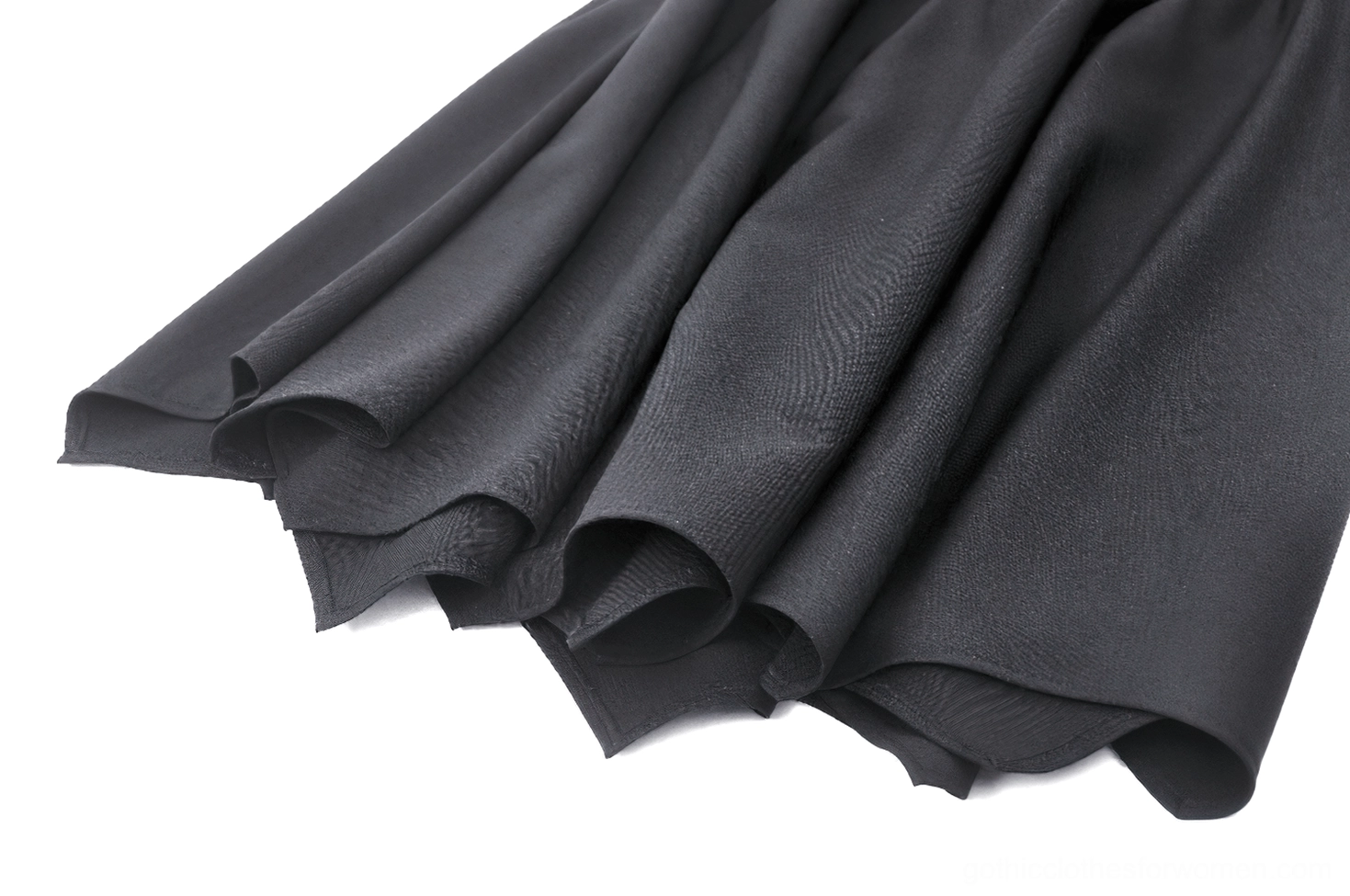 Black gothic A-line skirt showing asymmetrical hem silhouette from angle