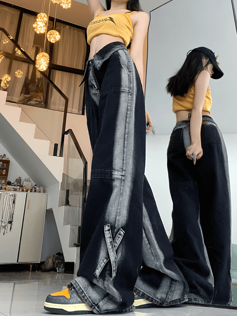 Alternative women's black denim trousers in high-waist cut, demonstrating loose-fit silhouette and contemporary gothic aesthetic