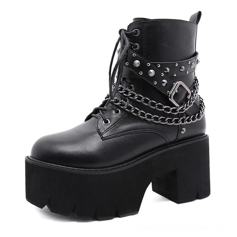 Single black gothic ankle boot showing three-quarter front view with metal chain straps and stud accents on white studio backdrop