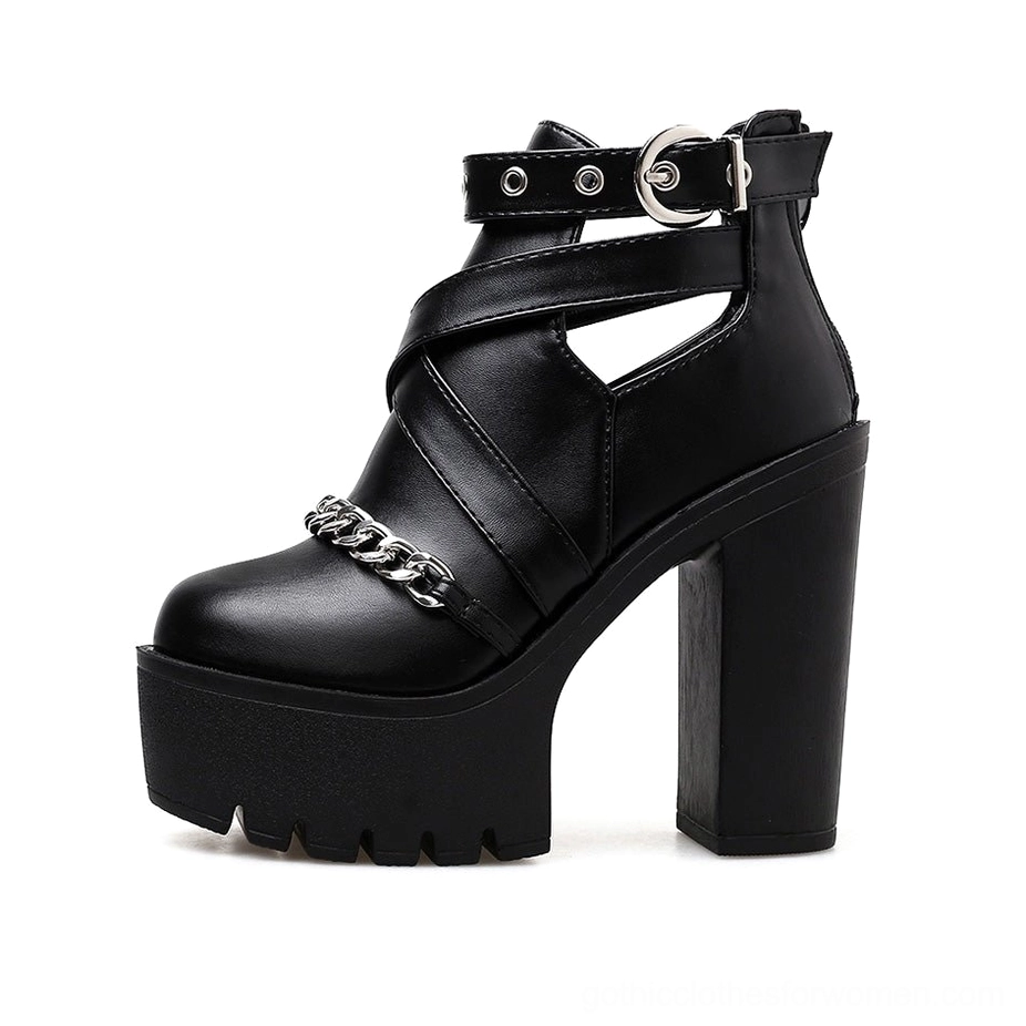 Black gothic ankle boots left side view highlighting round toe silhouette and metal buckle strap closure detail