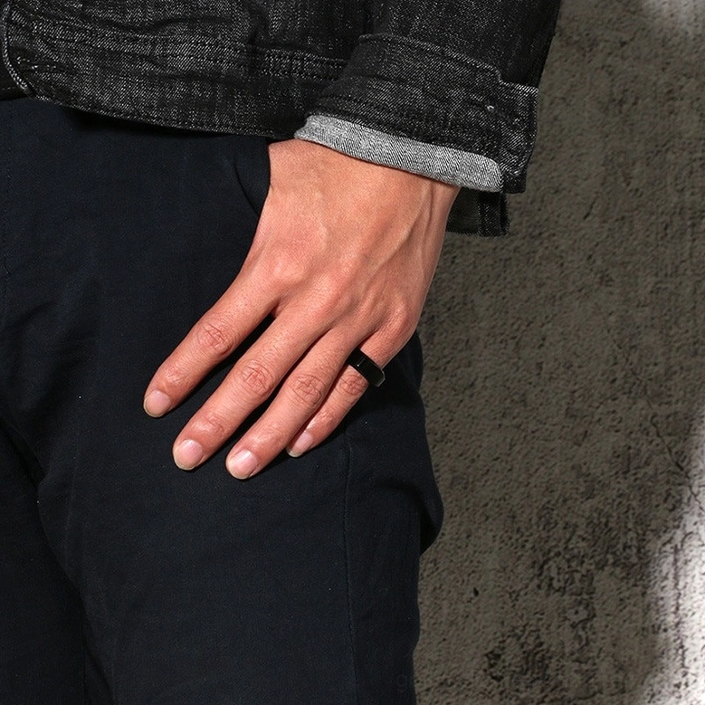 Black IP-plated stainless steel gothic band ring worn on male finger showing minimalist punk styling