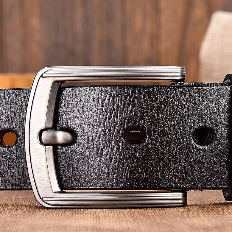 Black gothic leather belt front view, highlighting wide rectangular silver buckle, punched belt holes, and pebbled leather texture