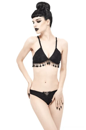 Black gothic brocade bikini set front three-quarter view on goth model with tassel fringe and front lacing details