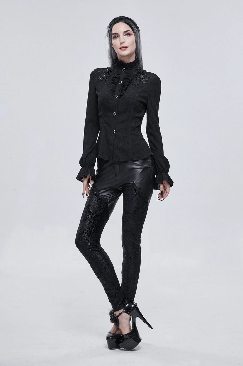 Back view detail of black gothic blouse showing lace-up back, fitted waist cinching, and sleeve construction