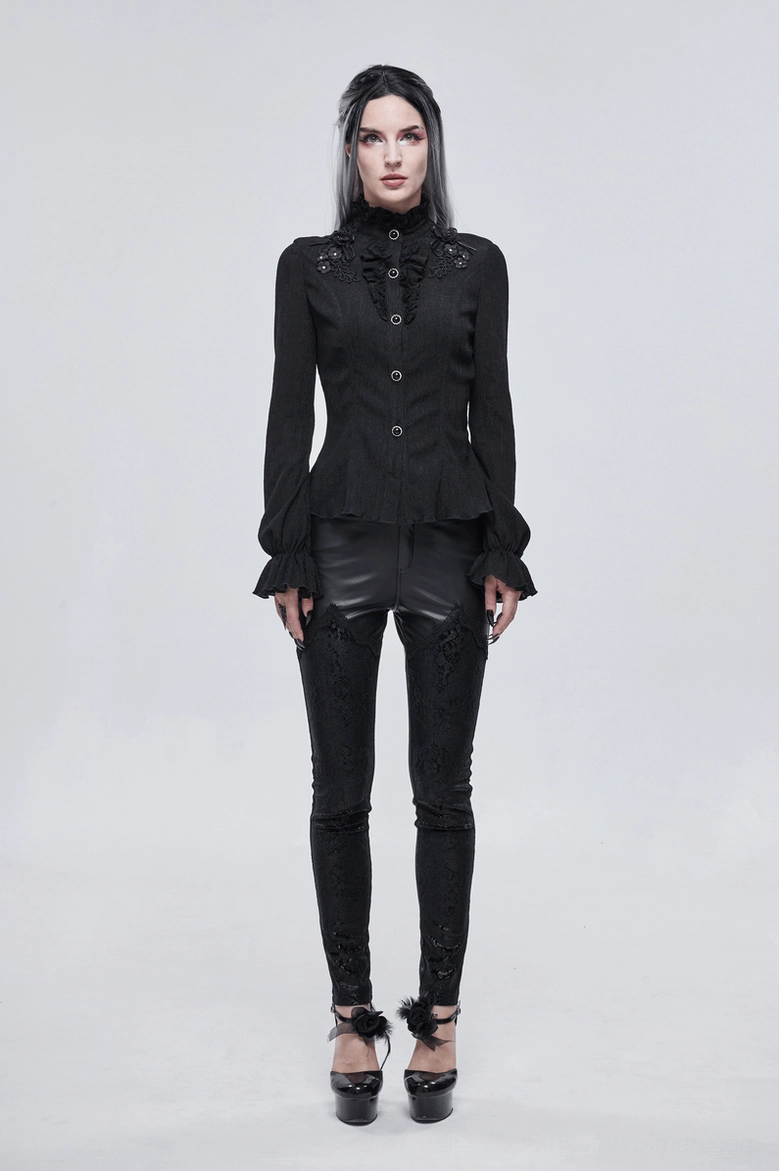 Front detail shot of black gothic blouse highlighting ruffled stand collar, gem buttons, and appliqué embellishments
