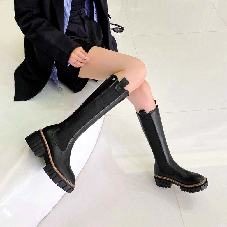 Black leather gothic platform boots styled with professional black blazer corporate goth aesthetic low angle sole detail