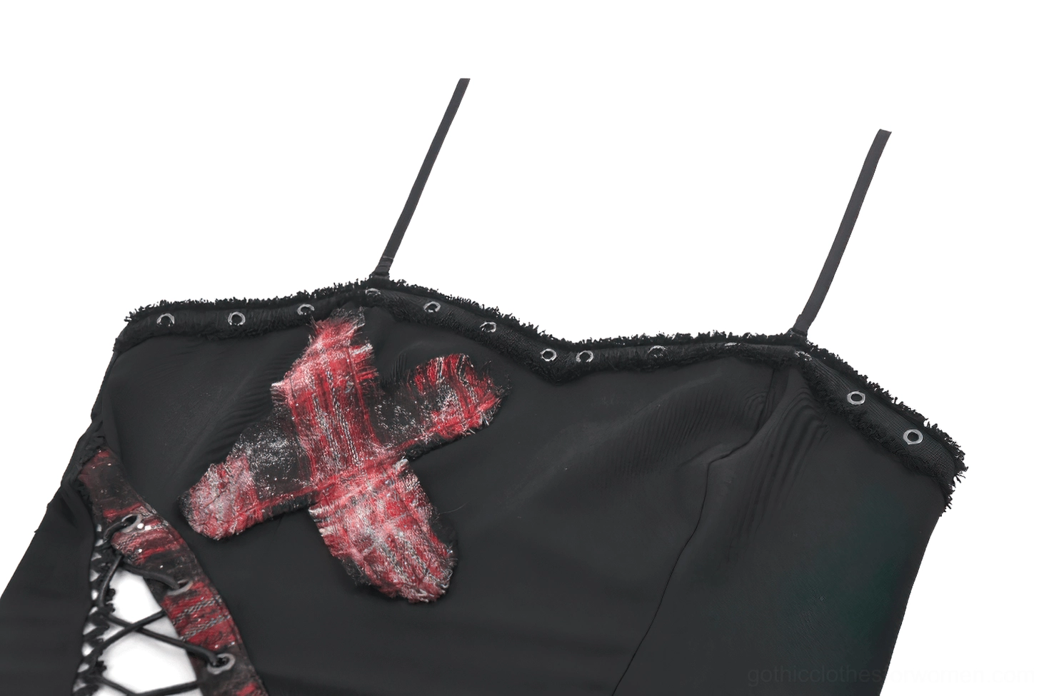 Close-up detail of sweetheart neckline with metal grommet trim and red plaid cross patch on black gothic corset cami