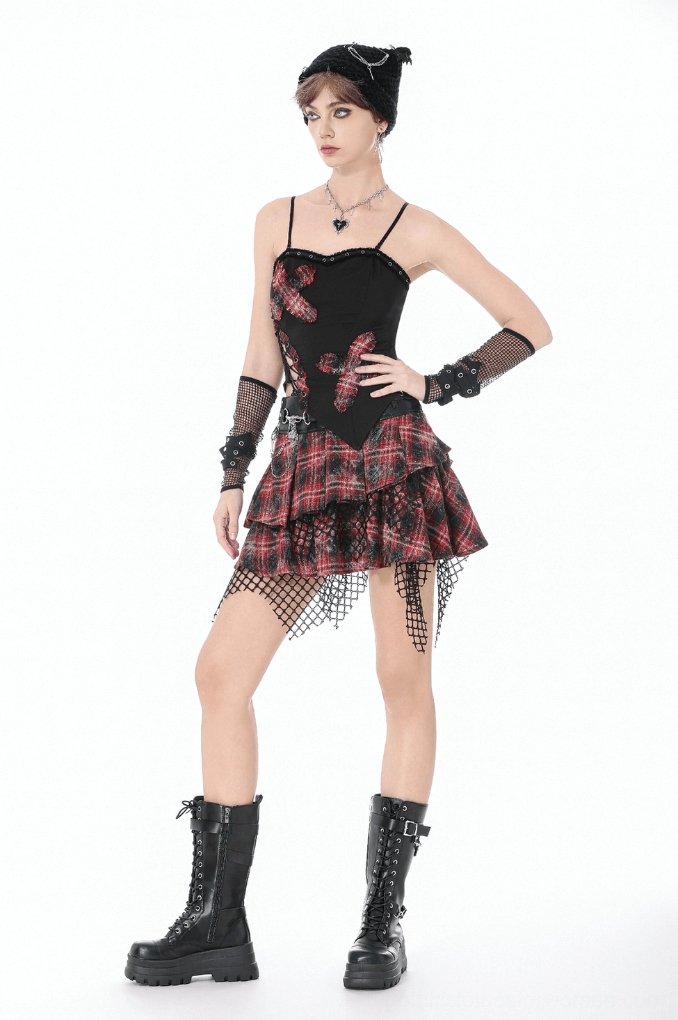 Black gothic corset cami top close-up showing red tartan patches, grommet details, and punk-inspired design elements