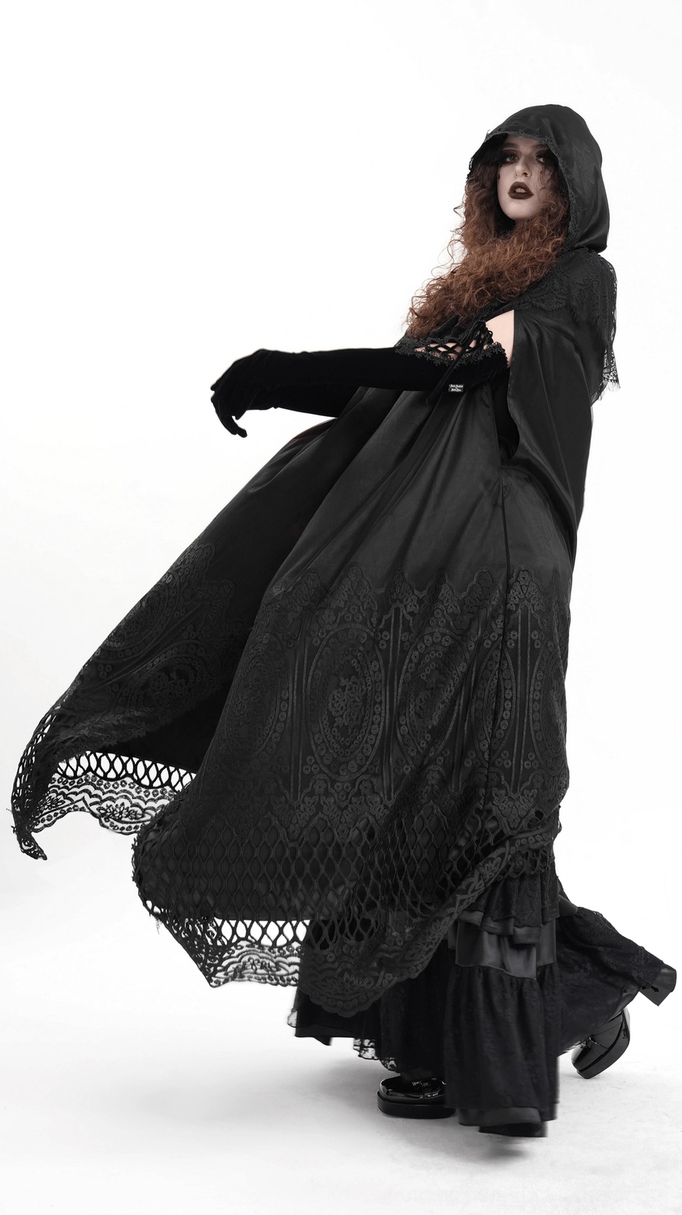 Full-body view of black hooded gothic cape with intricate lace patterns and sheer mesh panels on display form