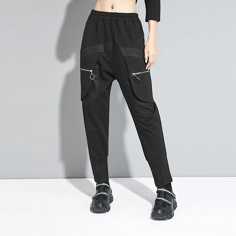Black alternative harem cargo pants front three-quarter view with zippered pockets and tapered leg