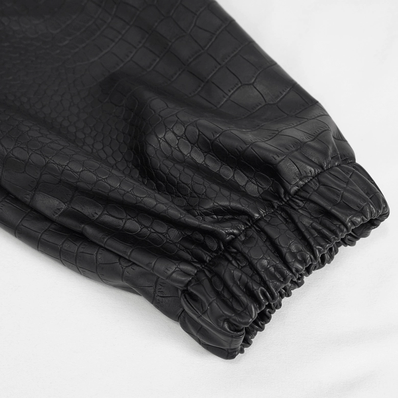 Black gothic cargo pants detail view of front pocket and metal chain placement