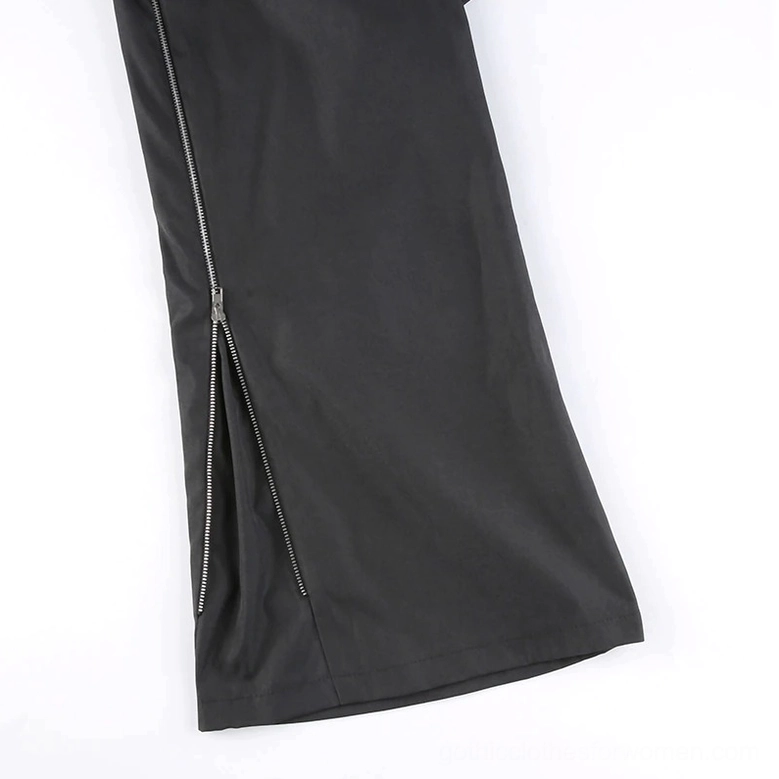 Full-length view of black gothic cargo pants demonstrating wide-leg cut and all hardware embellishments