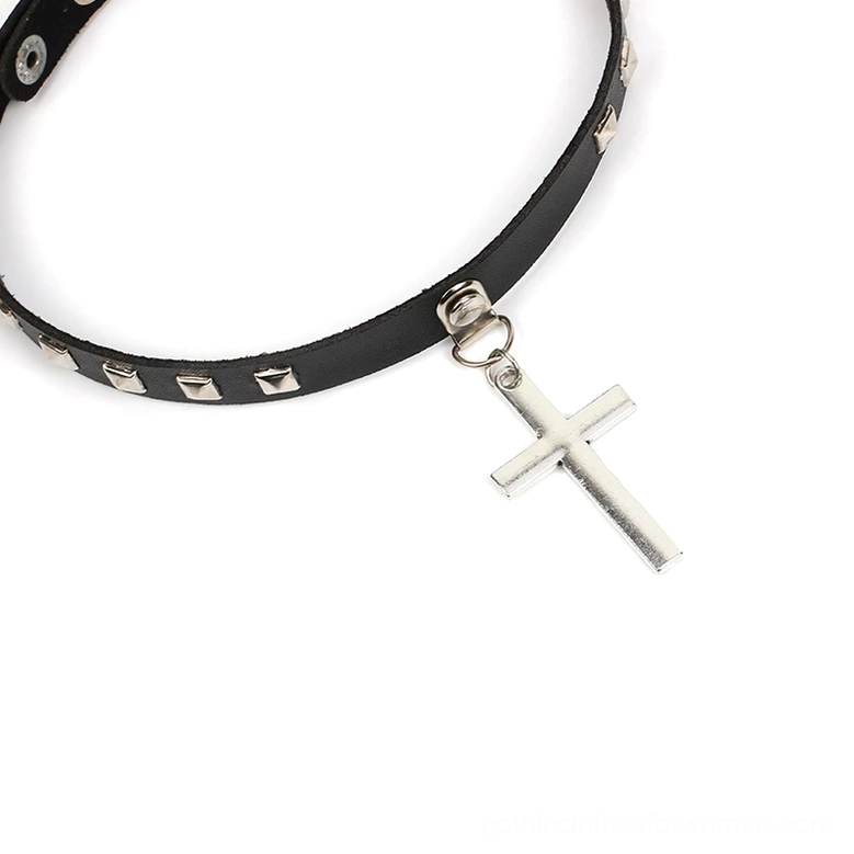Angled flat lay shot of black leather gothic choker showing silver rivets and hanging cross charm