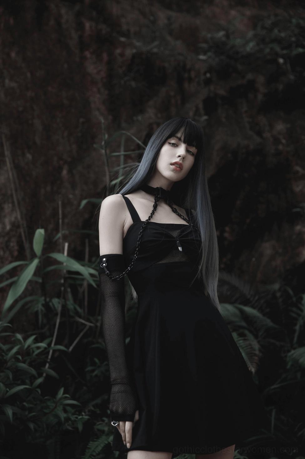 Black fishnet gothic choker worn by model showcasing transparent mesh design and chain harness aesthetic from frontal angle