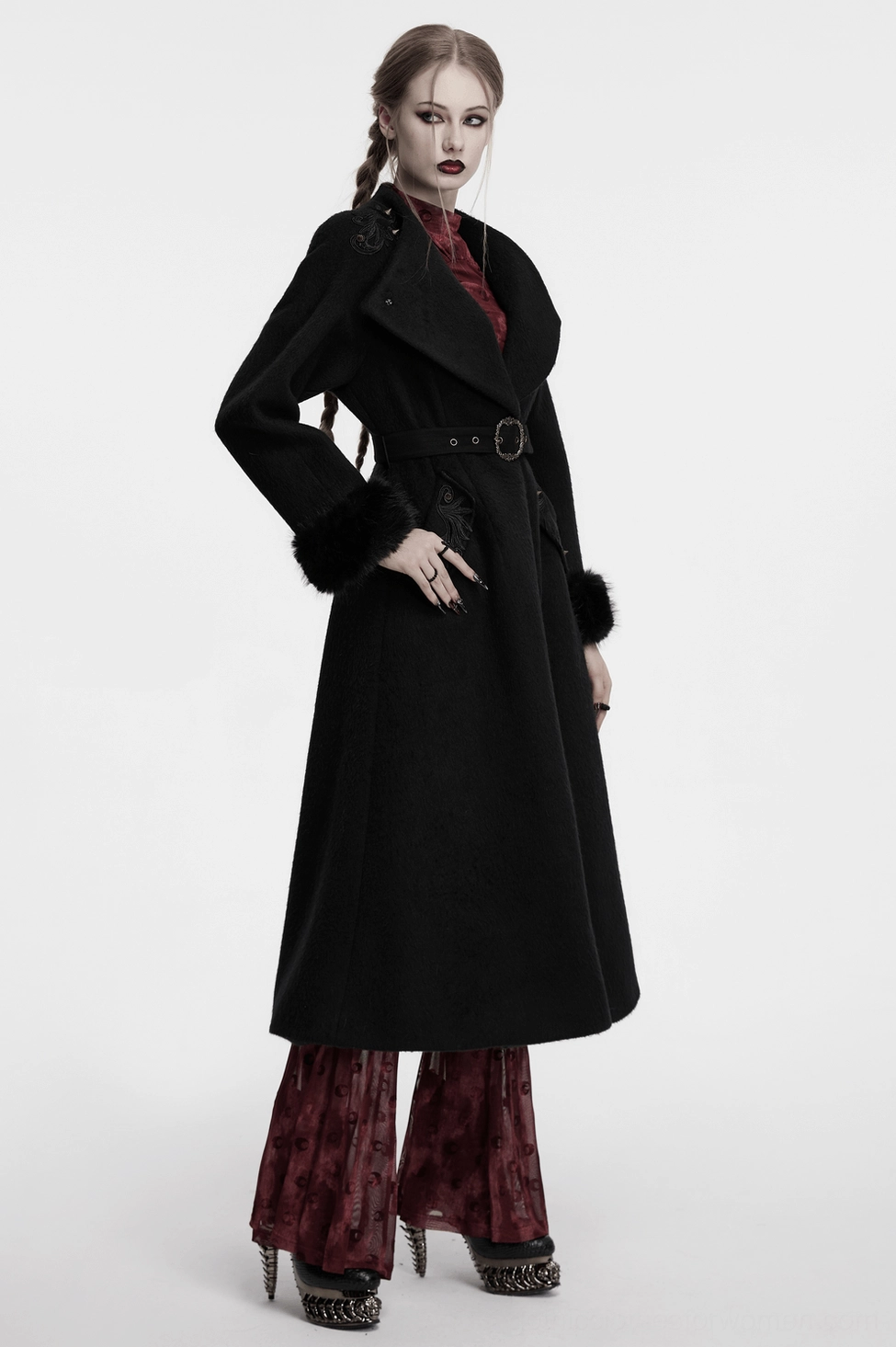 Black gothic coat with ornate baroque appliques and pointed studs showcasing intricate embellishment craftsmanship