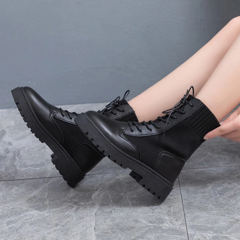 Black gothic lace-up platform combat boots - women's ankle boots styling flat lay on neutral background