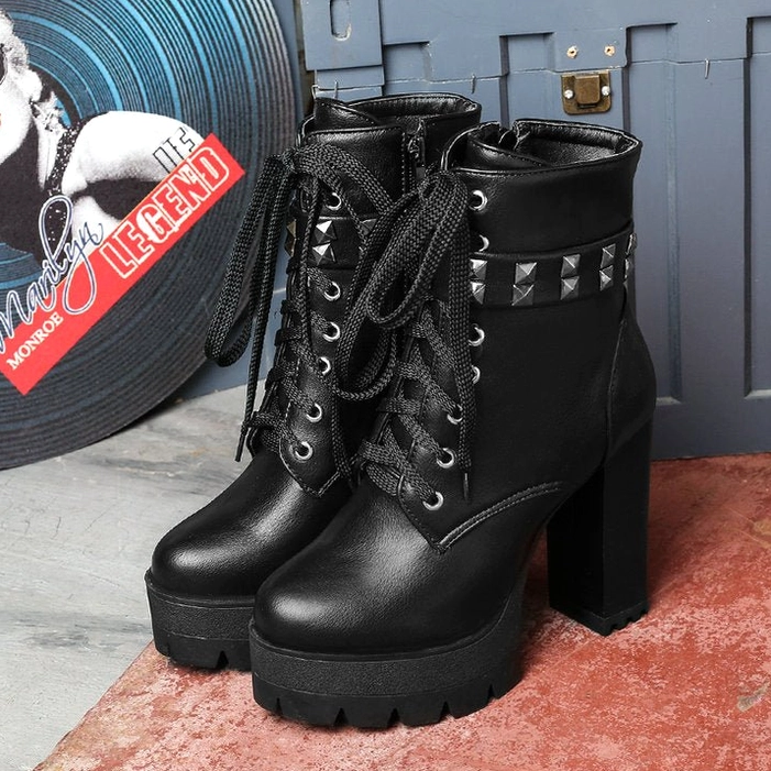 Black leather gothic combat heeled boots with platform sole and lace-up design, low-angle front view
