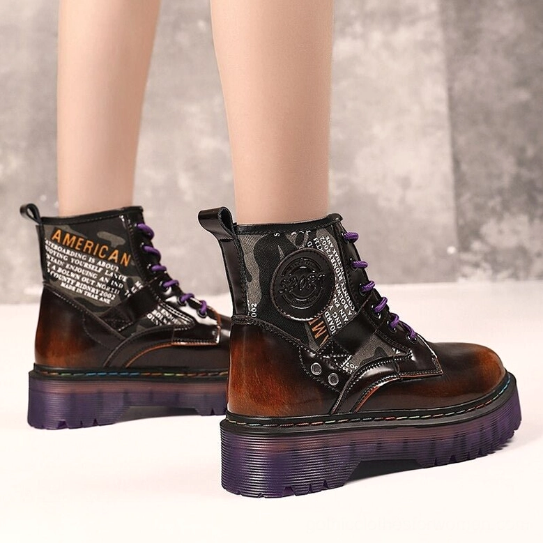 Close-up texture detail of glossy PU leather and lace-up closure on black gothic combat boot