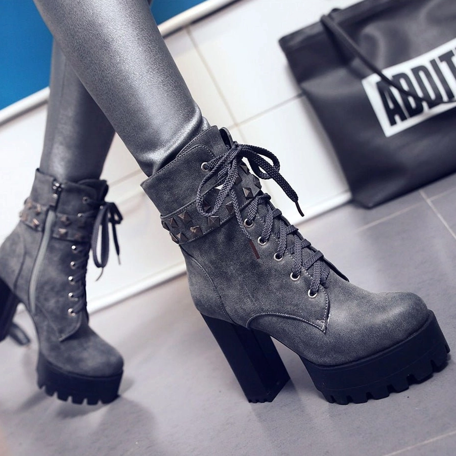 Black leather gothic combat boots showing zipper closure and pyramid stud embellishments