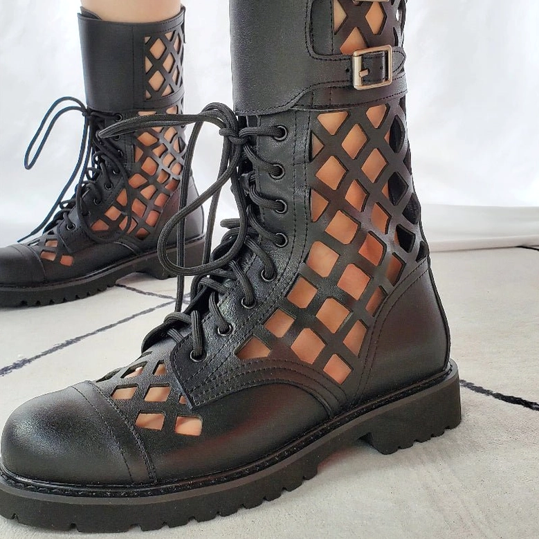 Black gothic lace-up combat pumps with side buckle strap and thick lug sole showing low front angle detail