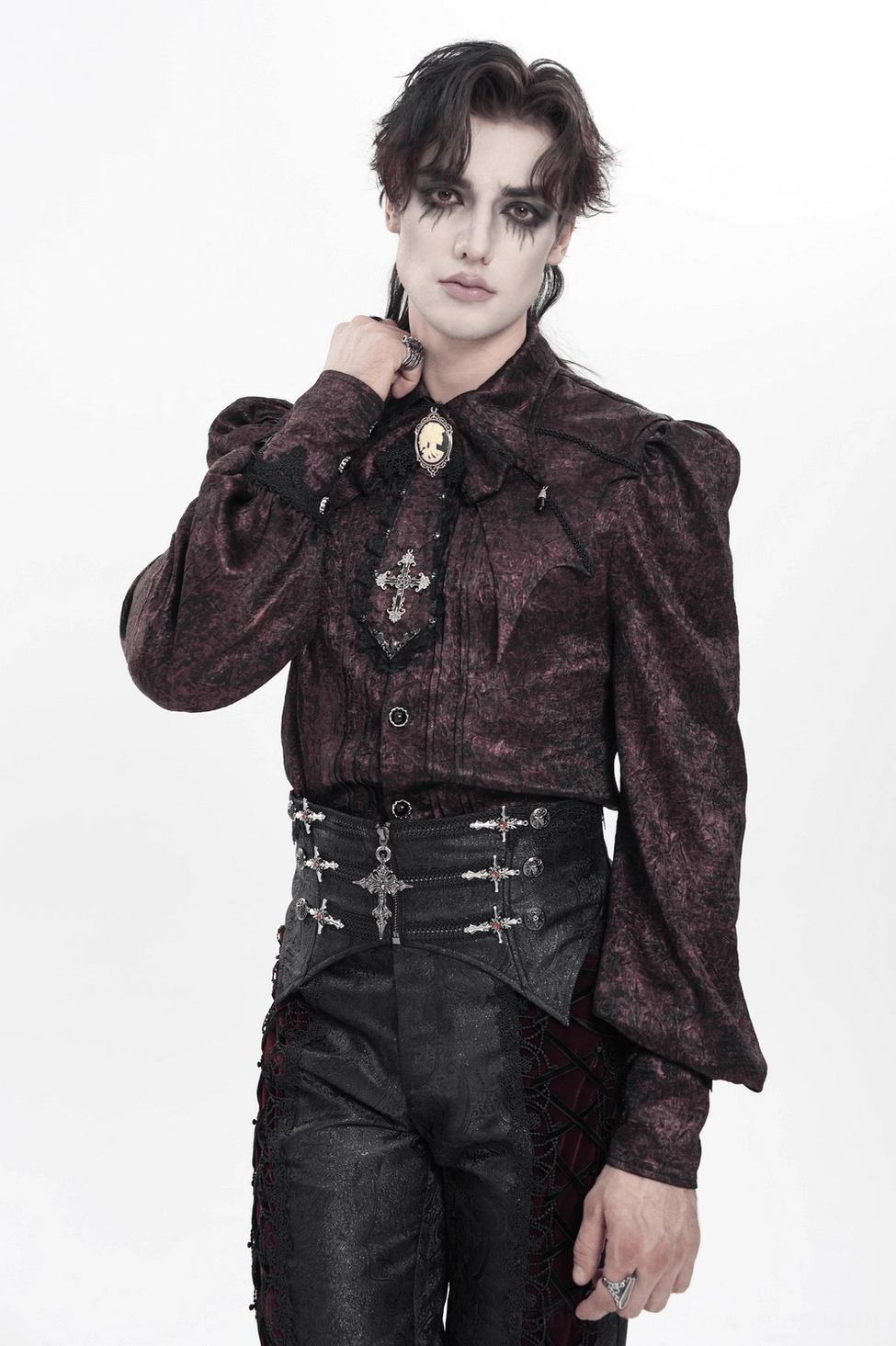 Angled view of black gothic corset belt showing multiple cross and stud embellishments on jacquard fabric