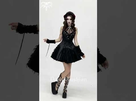 Black gothic corset dress styled with fingerless gloves, platform boots, and floral hair accessory on model side view